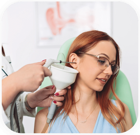 Woman at her local hearing clinic to professionally remove earwax