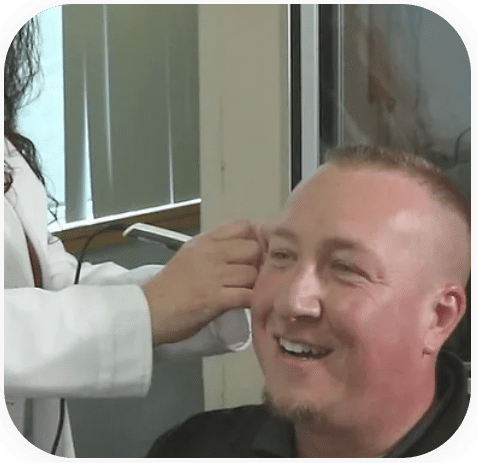 Dr. Jessica Woods examing a patient's ears