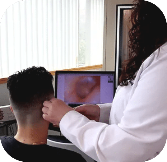 Dr. Jessica Woods examining inside a patient's ear