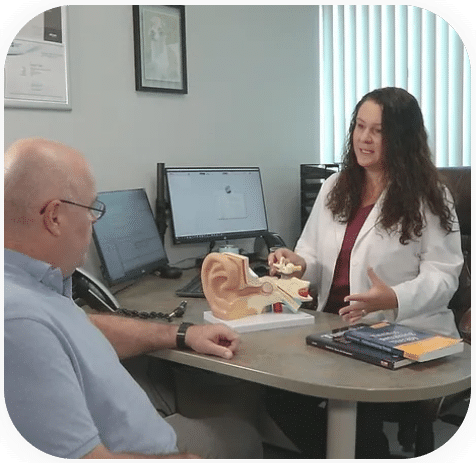 Dr. Jessica Woods speaking to a patient about tinnitus treatment